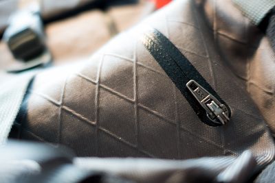 Waterproof zippers bonded in laser cut slots